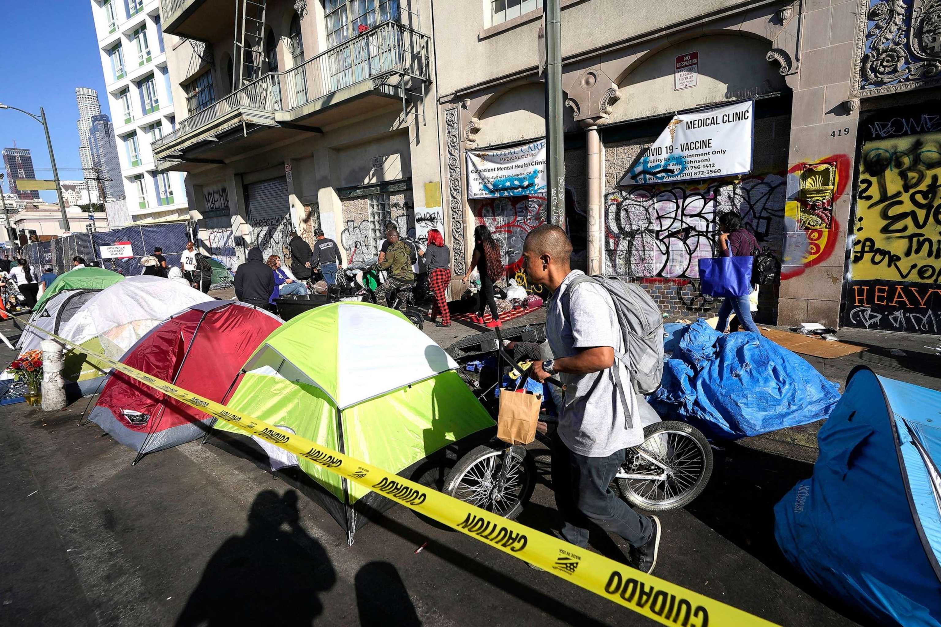 PHOTO: People line up at makeshift tents during the Los Angeles County Skid Row's annual party that hosts thousands of homeless and others in need, in downtown Los Angeles on Nov. 24, 2022.